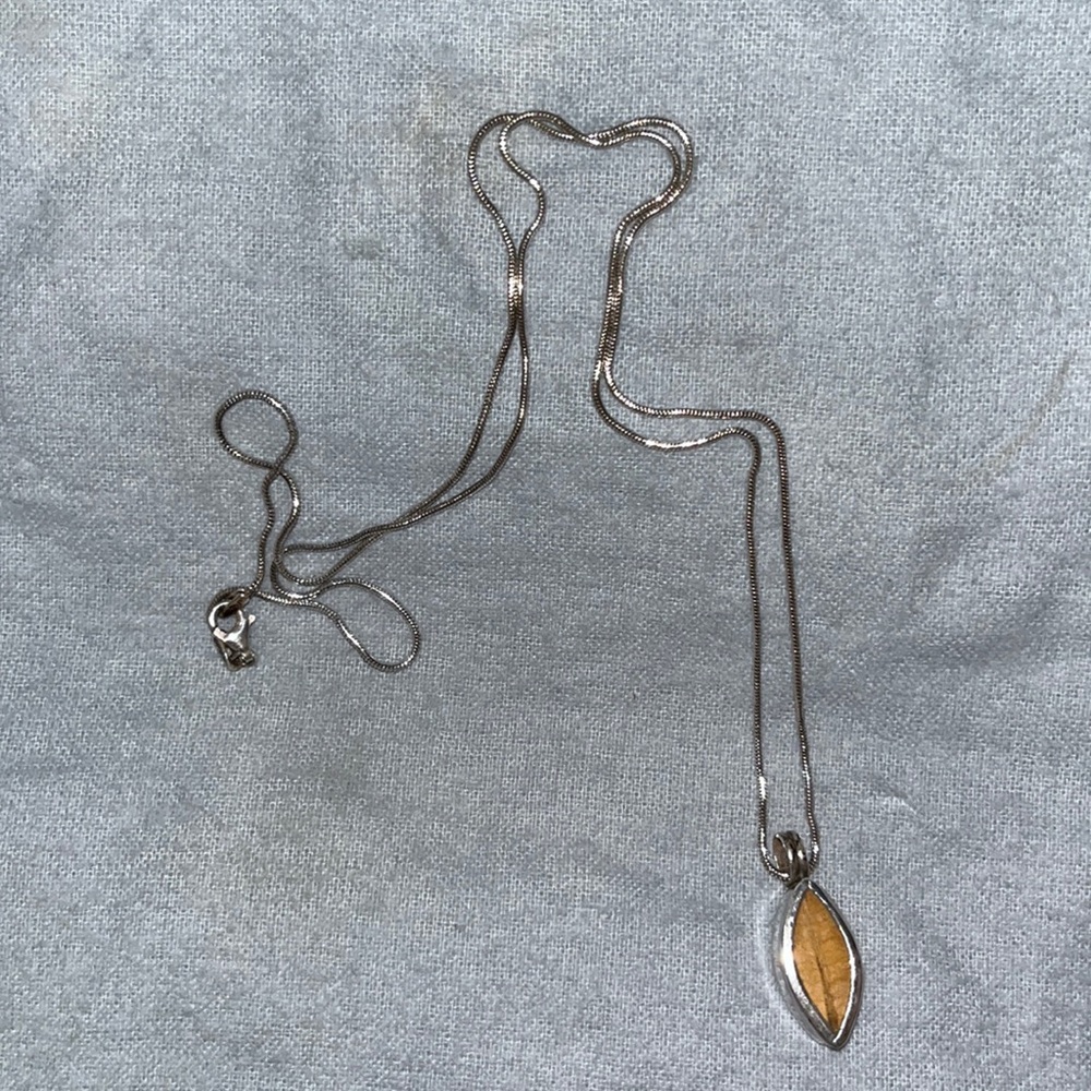 Coca leaf charm with chain.